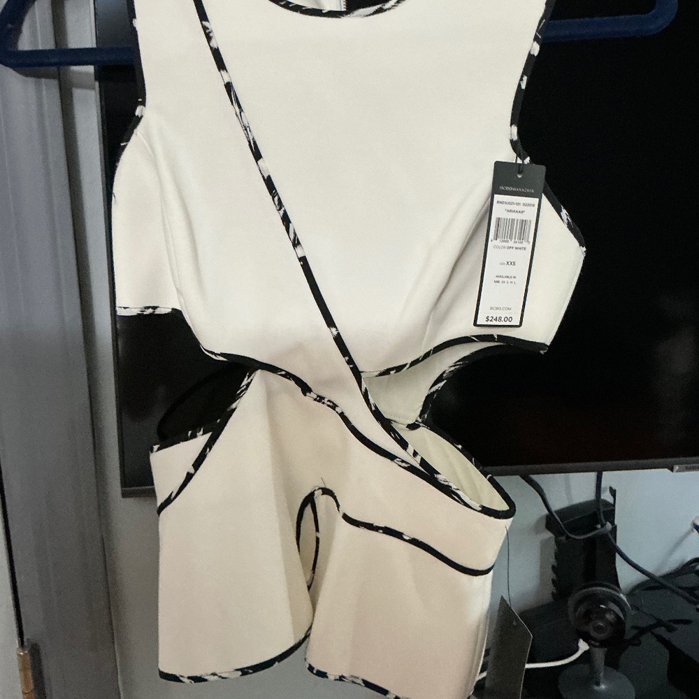 Bcbg peplum off white cut out peplum sleeveless top.